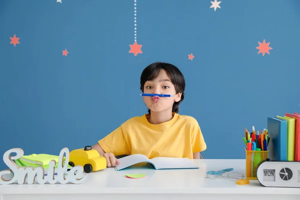 Little Boy Having Fun While Doing Homework Color Background — Stock Photo, Image