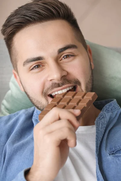 Handsome Young Man Eating Chocolate Home — Stock Photo, Image