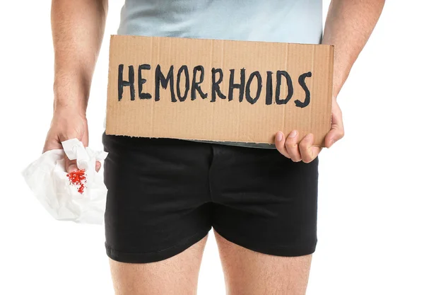 Young Man Holding Paper Text Hemorrhoids White Background Closeup — Stock Photo, Image