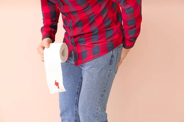 Young Man Holding Toilet Paper Blood Spot Color Background Hemorrhoids — Stock Photo, Image