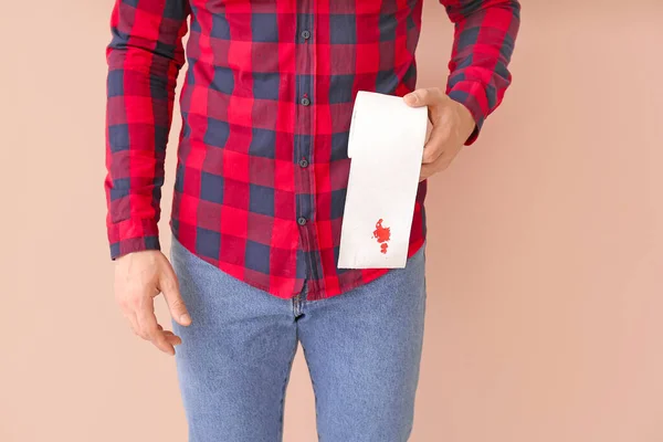 Young Man Holding Toilet Paper Blood Spot Color Background Hemorrhoids — Stock Photo, Image