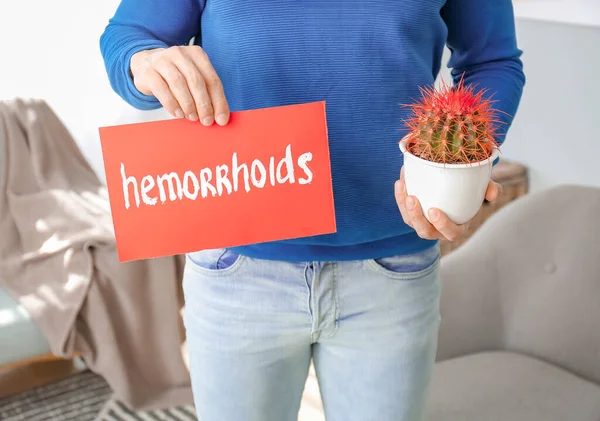 Young Man Holding Paper Text Hemorrhoids Cactus Home — Stock Photo, Image