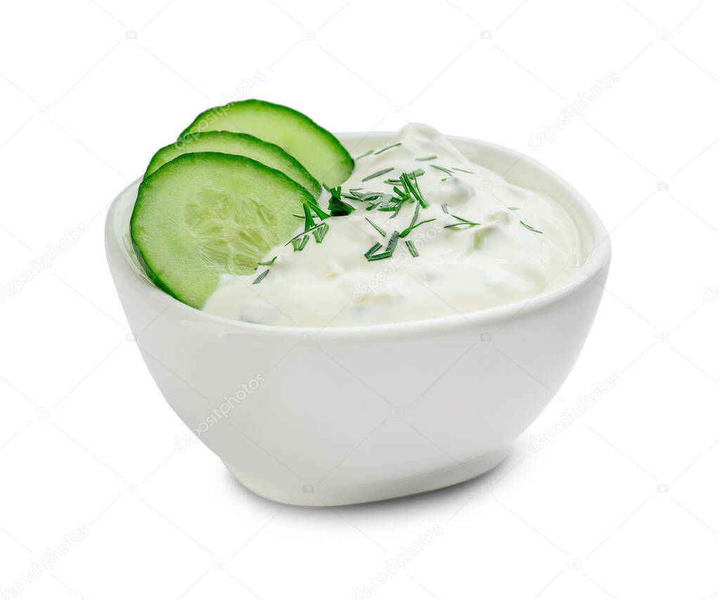 Delicious yogurt sauce with cucumber in bowl on white background