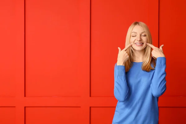 Happy woman with dental braces on color background — Stock Image Happy Woman Dental Braces Color Background Stock Picture