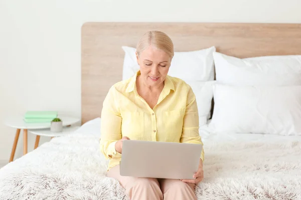 Senior woman video chatting at home