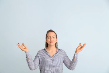 Renkli arka planda meditasyon yapan genç iş kadını portresi