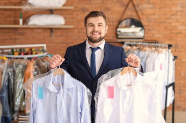 Modern kuru temizlemecide çalışan işçilerin portresi.