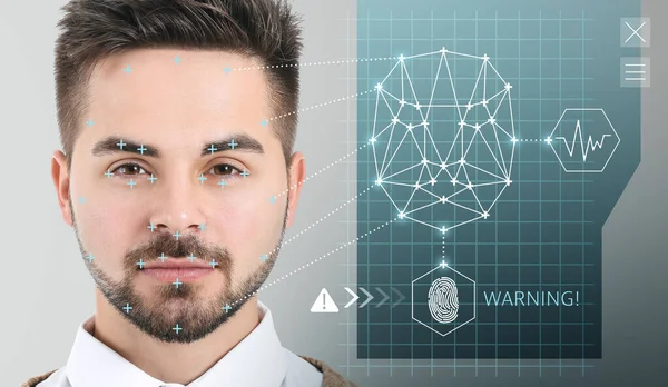 Young businessman using facial recognition system for data protection