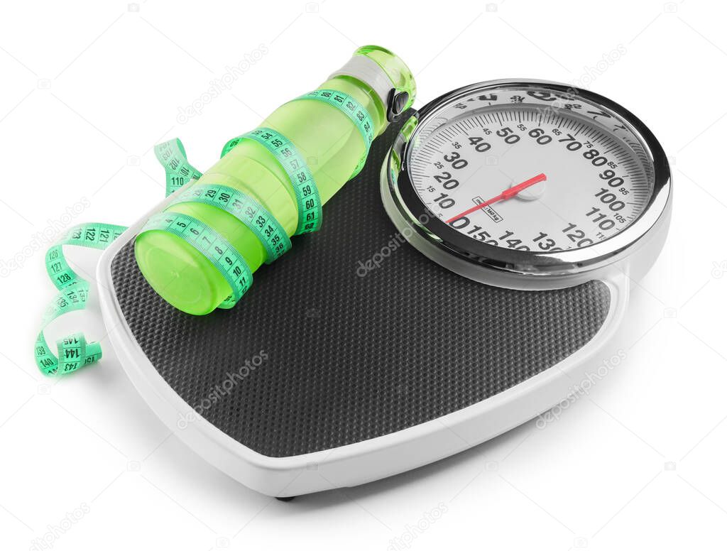 Weight scales with measuring tape and bottle of water on white background. Slimming concept