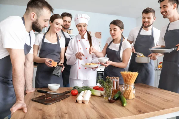 Köchin Und Gruppe Junger Leute Bei Kochkursen — Stockfoto