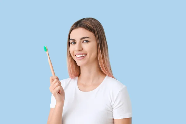 歯ブラシを背景にした美しい若い女性 — ストック写真