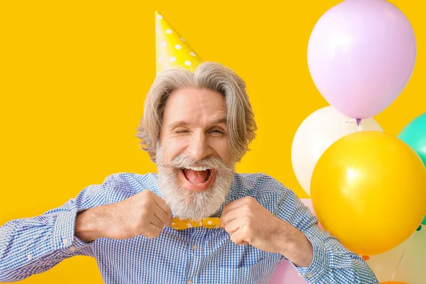 Senior Man Celebrating Birthday Color Background — Stock Photo, Image