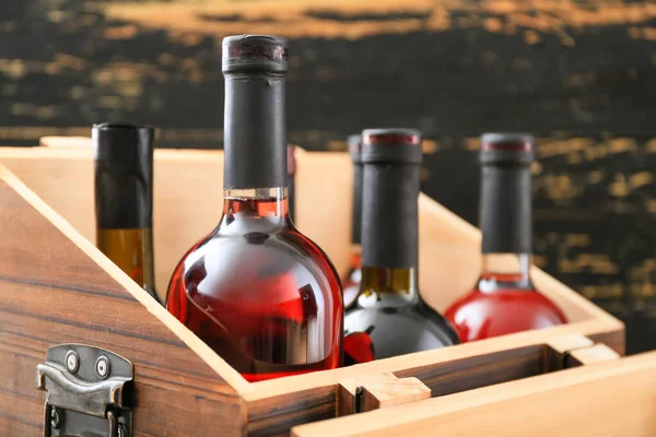 Box with bottles of wine on table