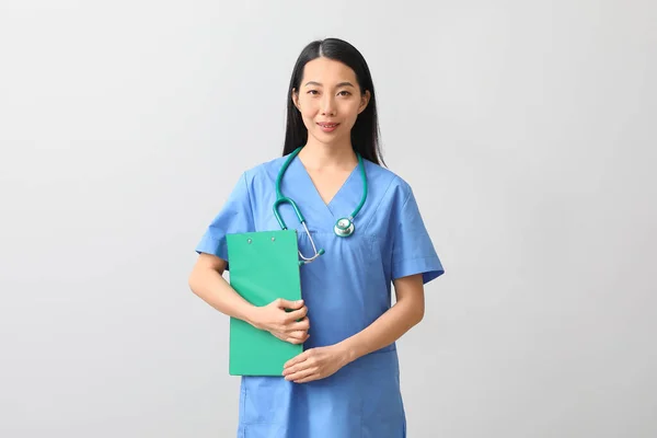 Femme Asiatique Médecin Avec Presse Papiers Sur Fond Clair — Photo