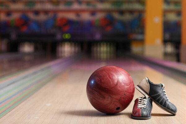 Ball and shoes on lane in bowling club