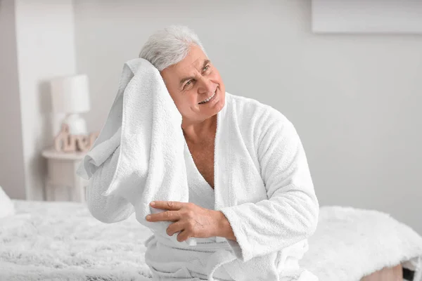 Morning of happy mature man in bedroom