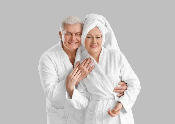 Mature Couple Bathrobes Grey Background — Stock Photo, Image