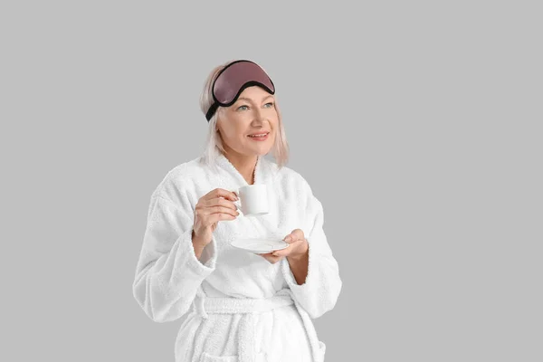 Mature Woman Bathrobe Sleep Mask Cup Coffee Grey Background — Stock Photo, Image