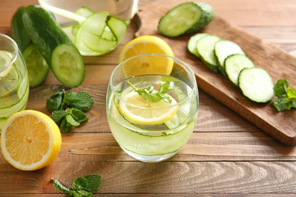 Glass of infused cucumber water on table