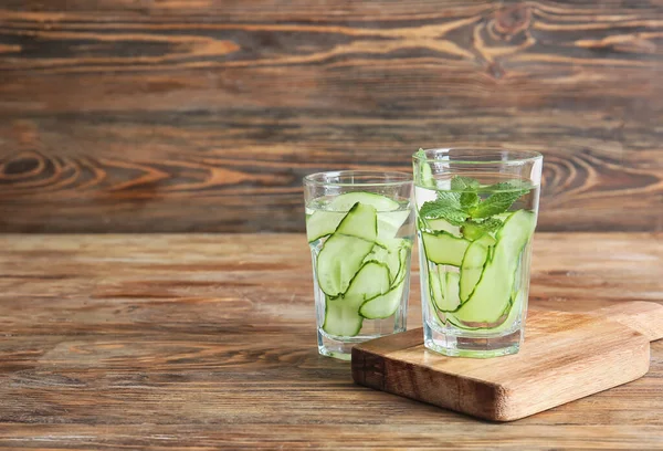 Glasses of infused cucumber water on table