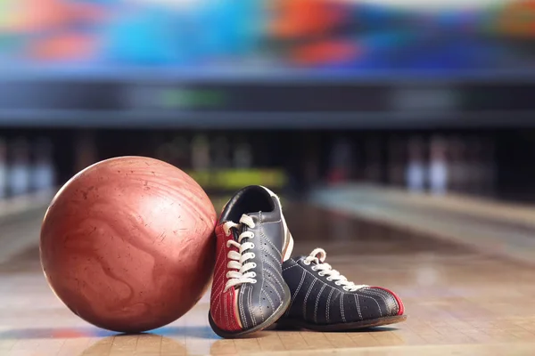 Shoes and ball on floor in bowling club