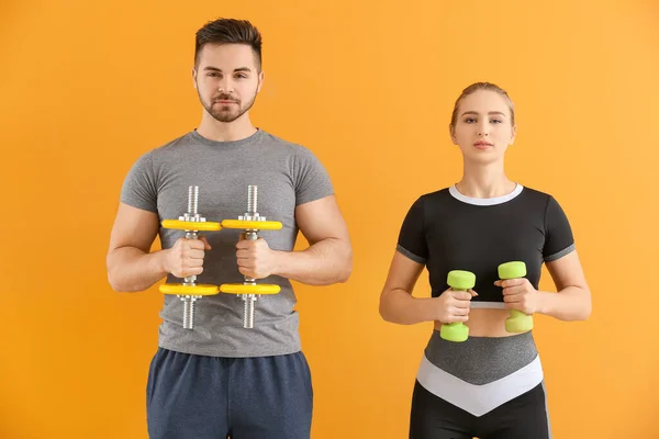 Sporty Young Couple Training Dumbbells Color Background — Stock Photo, Image