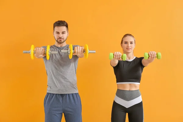Sporty Young Couple Training Dumbbells Color Background — Stock Photo, Image