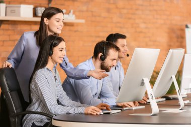 Profesyonel teknik destek ajanı gençlere ofiste eğitim veriyor.