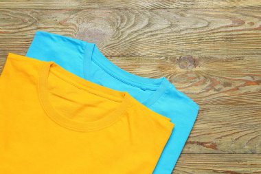 Ahşap arka planda farklı tarz tişörtler.
