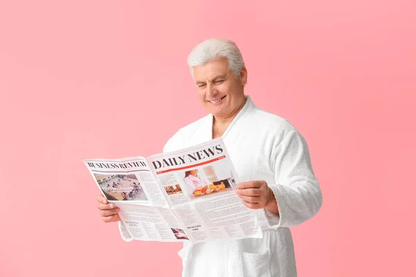 Mature Man Bathrobe Newspaper Color Background — Stock Photo, Image