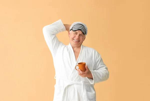 Happy Mature Man Bathrobe Sleep Mask Cup Coffee Color Background — Stock Photo, Image