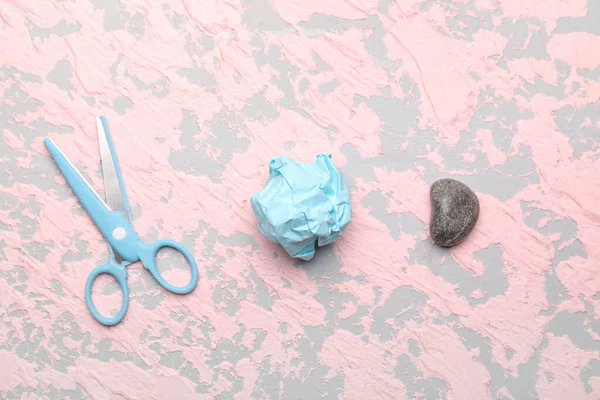 Scissors, rock and paper on color background