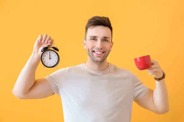 Young Man Coffee Alarm Clock Color Background — Stock Photo, Image