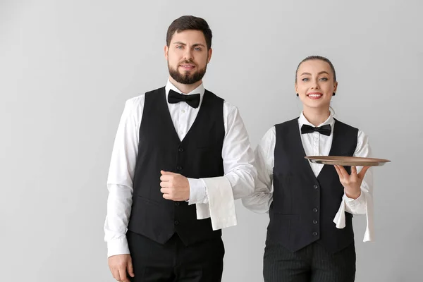 Male Female Waiters Grey Background — Stock Photo, Image