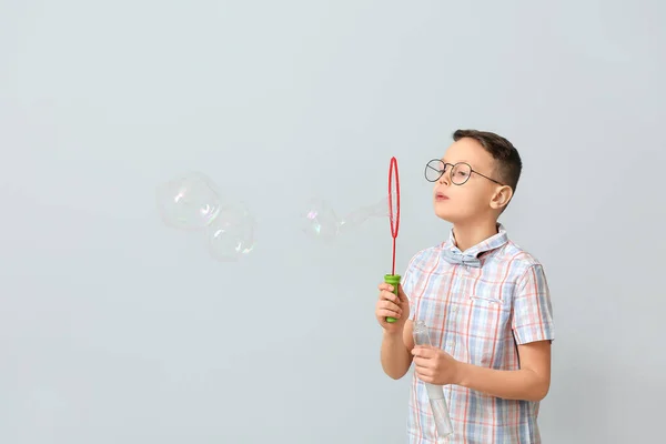 Cute Little Boy Blowing Soap Bubbles Light Background — Stock Photo, Image