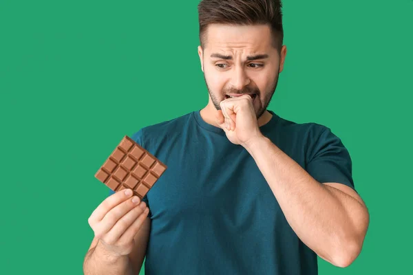 Bothered Young Man Tasty Chocolate Color Background — Stock Photo, Image