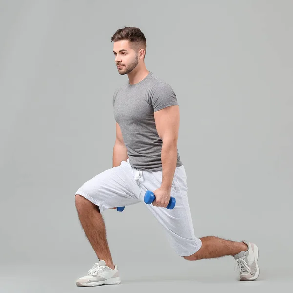 Sporty Young Man Training Dumbbells Grey Background — Stock Photo, Image