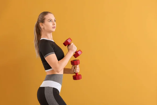 Sporty Young Woman Training Dumbbells Color Background — Stock Photo, Image