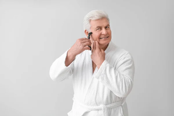 Happy Mature Man Bathrobe Shaving Grey Background — Stock Photo, Image