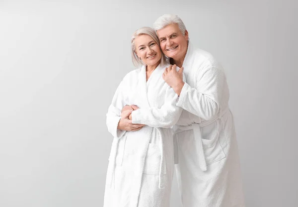 Mature Couple Bathrobes Grey Background — Stock Photo, Image