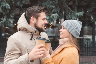 Genç çift dışarıda kahve içiyor.