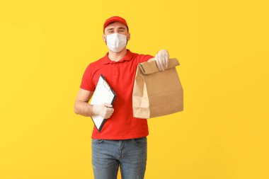 Yiyecek dağıtım şirketinin erkek kuryesi, tıbbi maske takıyor.