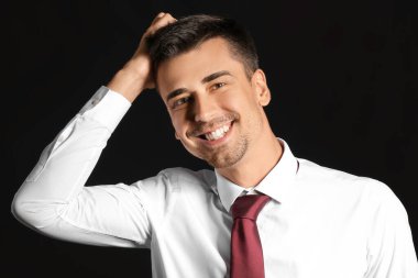 Koyu arka plan üzerinde yakışıklı işadamı portresi