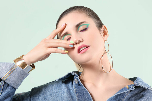 Молодая женщина с красивым маникюром на цветном фоне