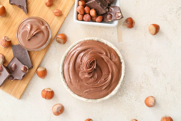 Bowls Tasty Chocolate Paste Hazelnuts Light Background — Stock Photo, Image