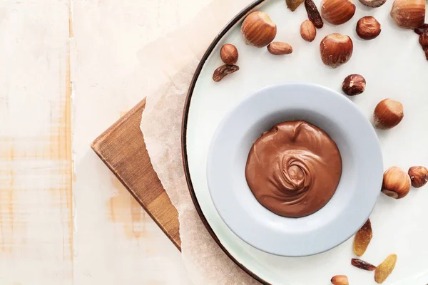 Plate Tasty Chocolate Paste Nuts Table — Stock Photo, Image