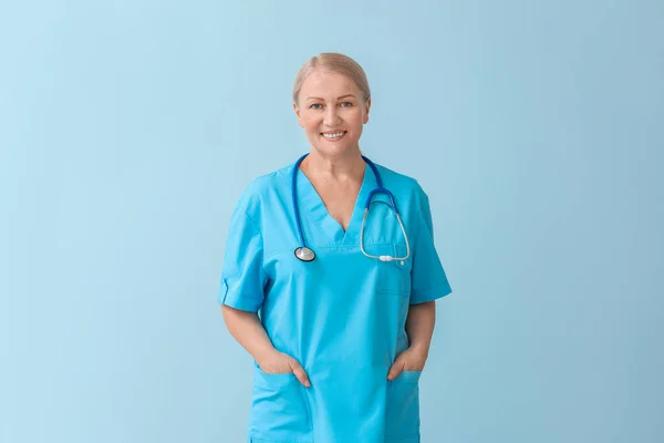 Mature Female Doctor Color Background — Stock Photo, Image