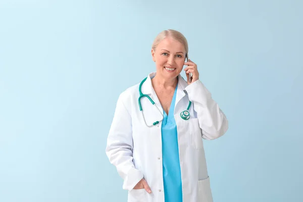 Mature Female Doctor Talking Phone Color Background — Stock Photo, Image