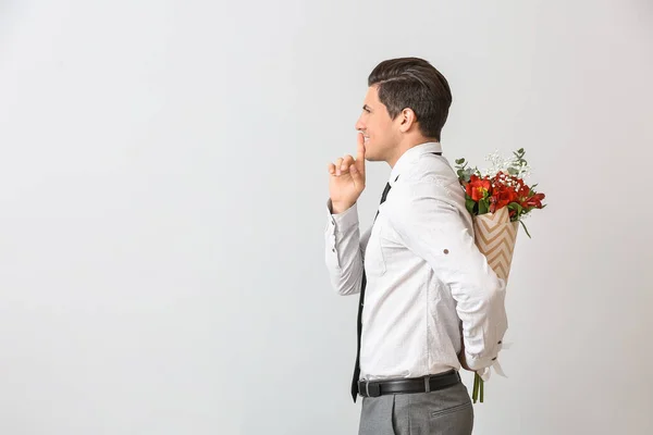 Handsome Man Bouquet Flowers Showing Silence Gesture Light Background — Stock Photo, Image