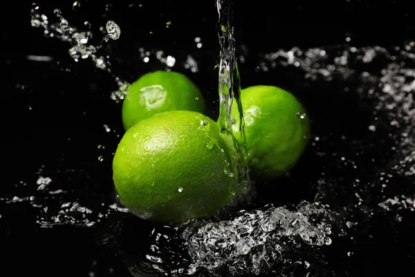Fresh Limes Water Splashes Dark Background Royalty Free Stock Images
